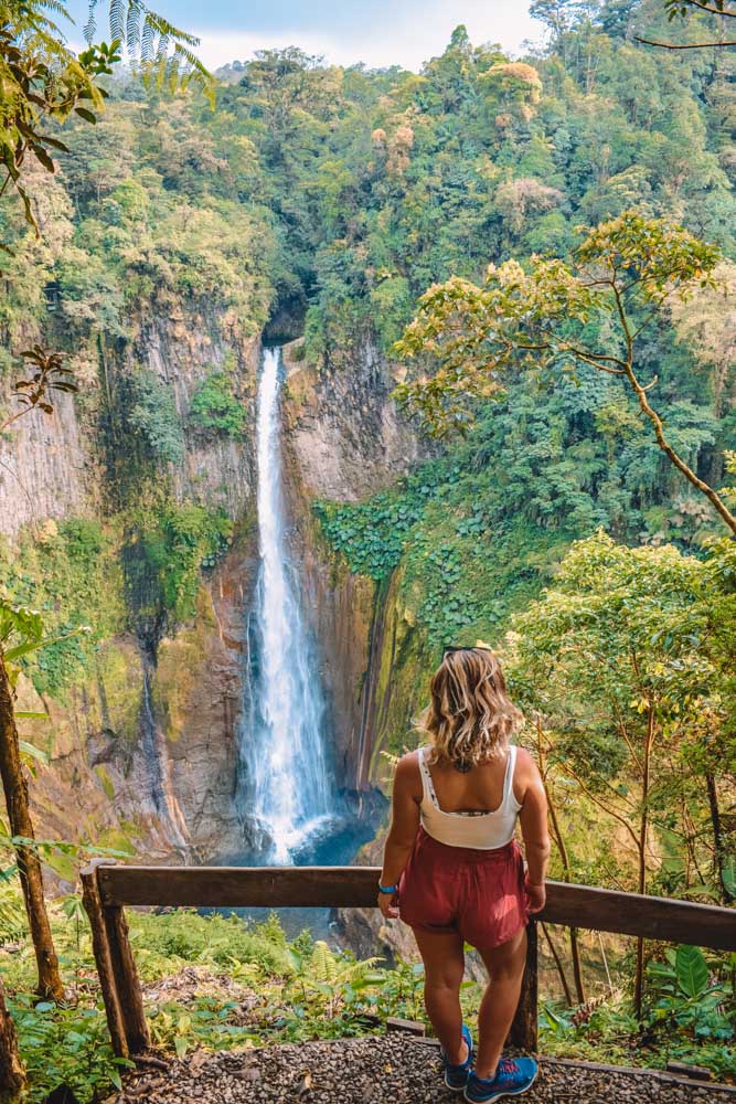 Woman looking at a waterfall